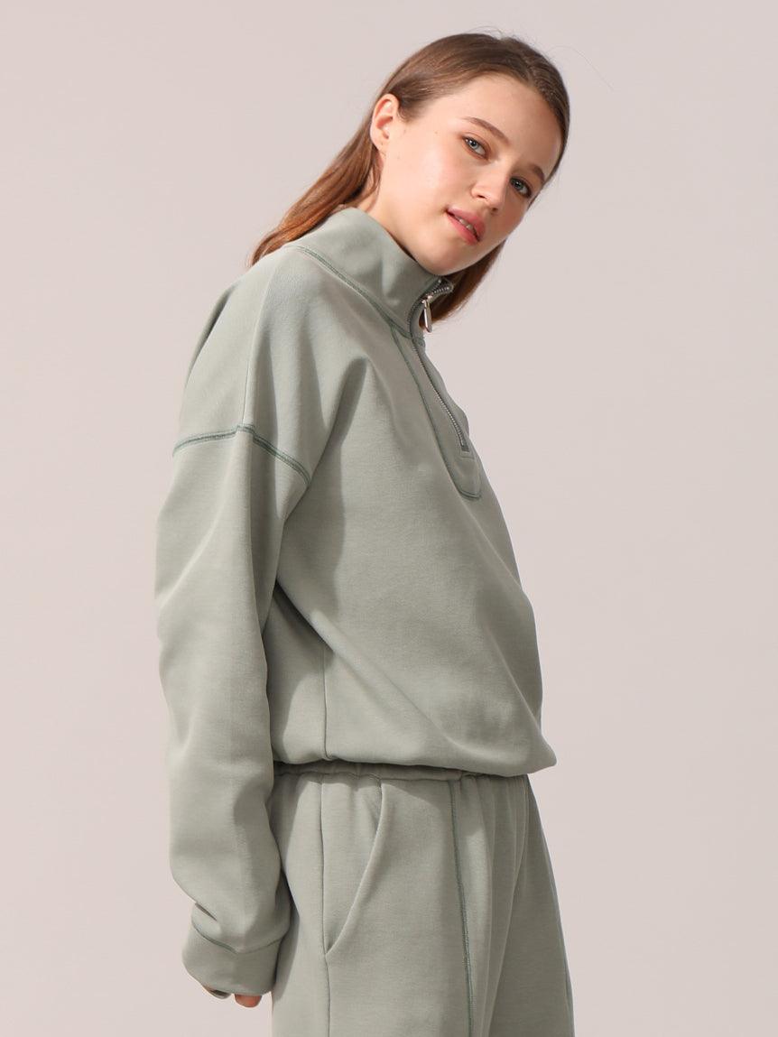 A woman wearing jacket in front of the camera