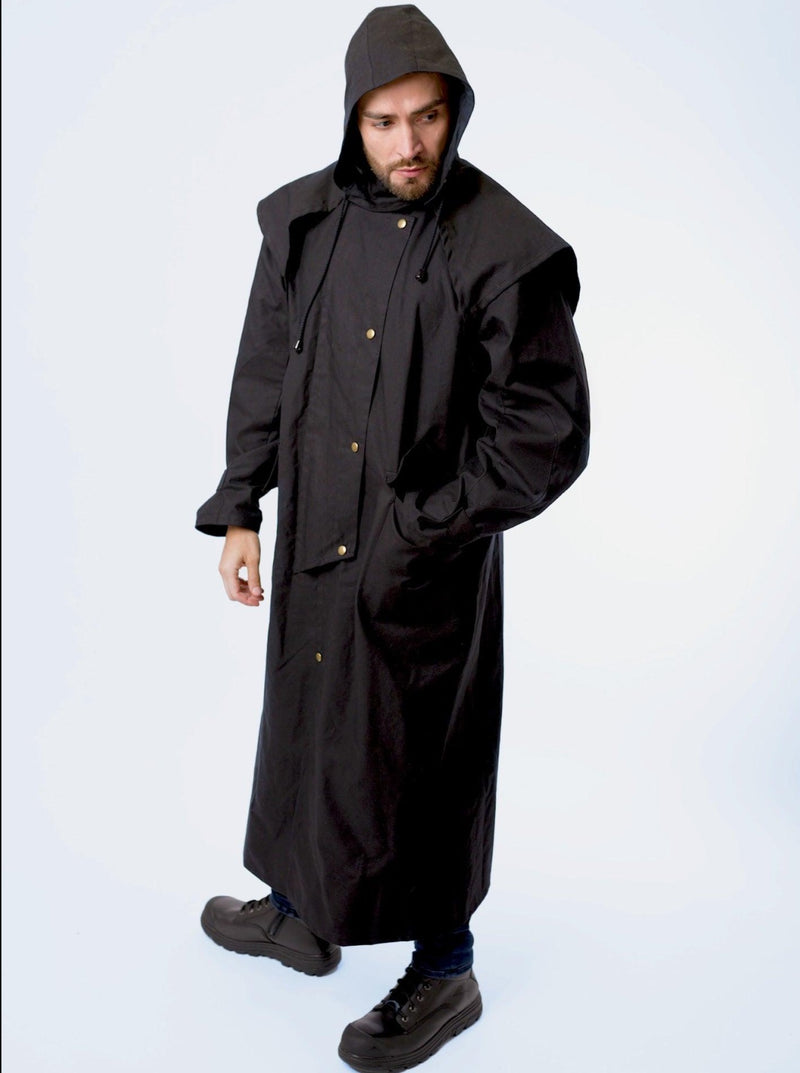 A man wearing claybourn oilskin riding coat with hood
