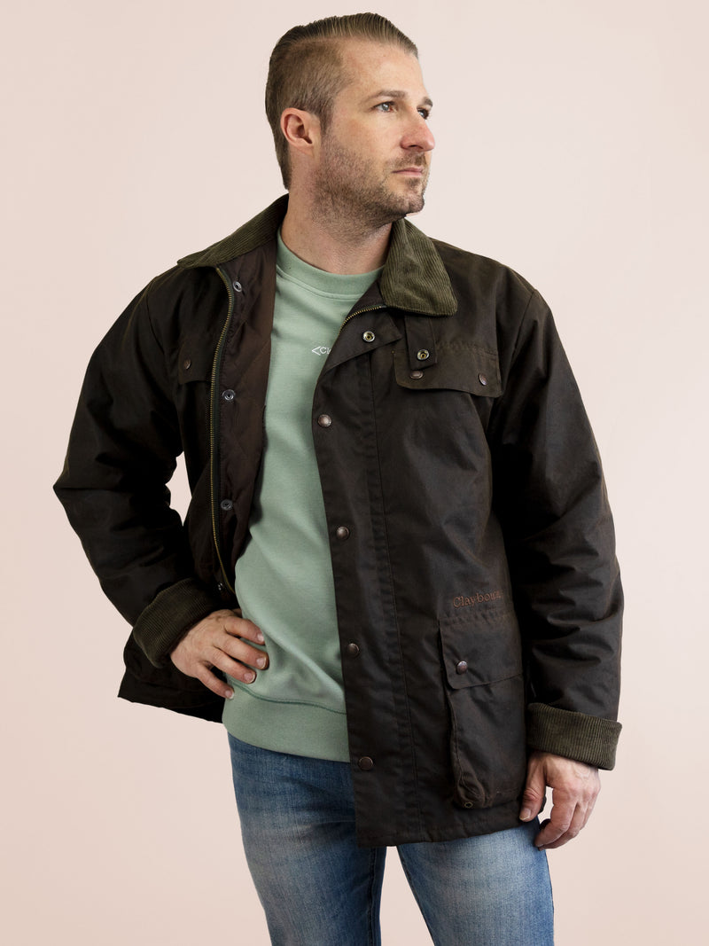 a guy wearing a brown jacket with green inner shirt