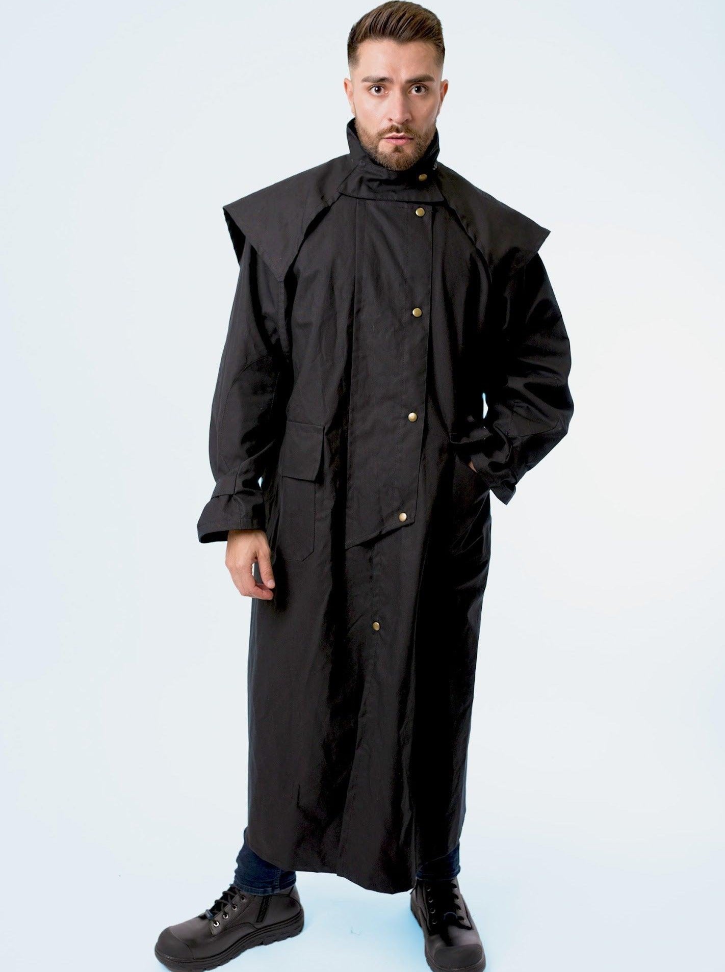 A man wearing claybourn oilskin riding coat with hood